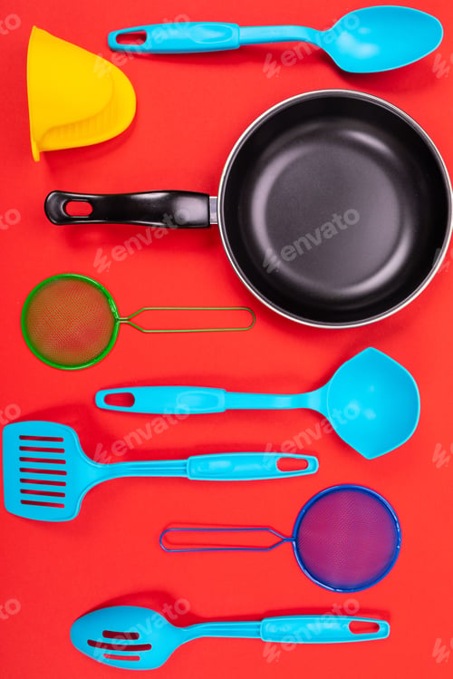 Preview: Cooking utensils in kitchen isolated on red background