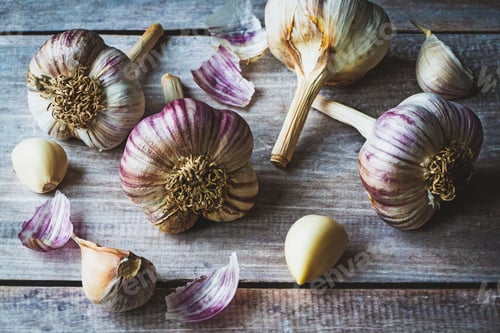 Preview: Garlic bulbs and cloves on wooden table background