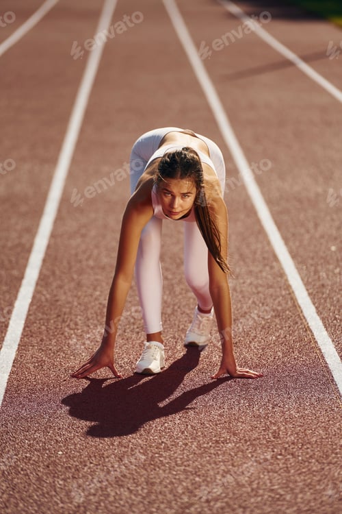 Preview: Woman in sportive clothes is exercising outdoors