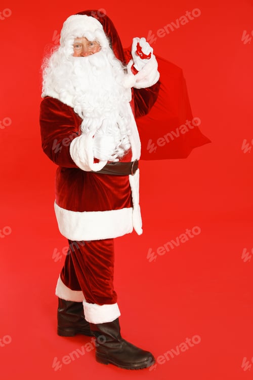 Preview: Authentic Santa Claus with bag full of gifts on red background