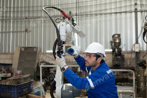 Preview: Engineer factory industry wearing safety uniform work and checking system of the welding robots for