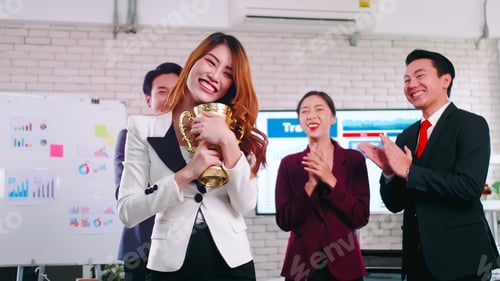 Preview: An employee of the company is proud to receive an award for a successful project.