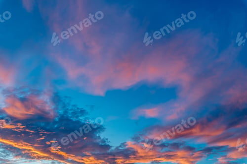 Preview: Beautiful shot of pink clouds in a clear blue sky with a scenery of sunrise