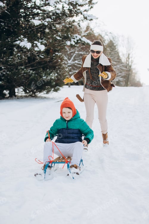 Preview: Mother and son enjoying winter sledding activity