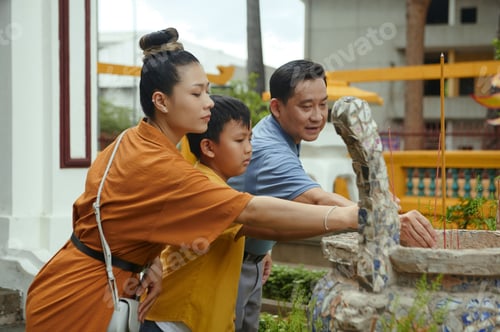 Preview: Family Using Aroma Sticks In Ancient Temple
