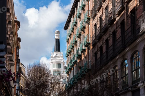 Preview: Charming architecture and blue skies define a picturesque street scene in Madrid, Spain.