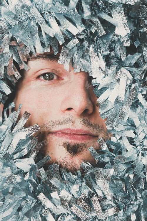 Preview: Young male surrounded by silver garland at christmas