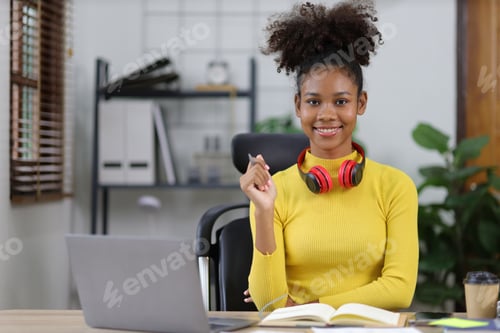 Preview: Portrait of beautiful happy african american woman in home office.