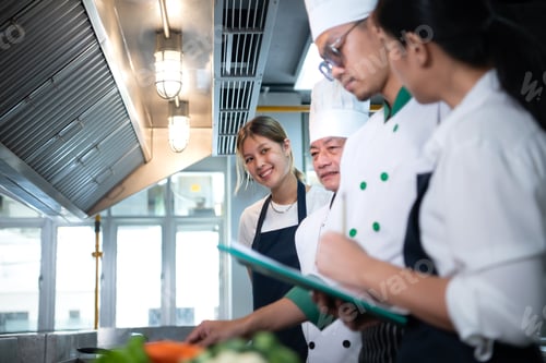 Preview: Portrait of a group of chefs and culinary students in the culinary Institute's kitchen.