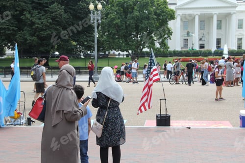 Preview: Muslim women in front of the White House using mobile device & looking at the presidential landmark
