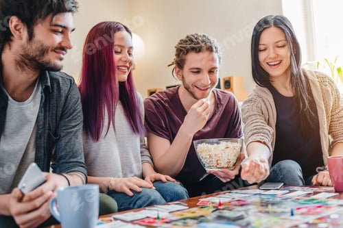 Preview: Few happy friends playing in table games indoor