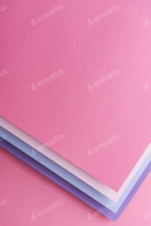Preview: top view of blue, white, pink and purple sheets of paper on pink background