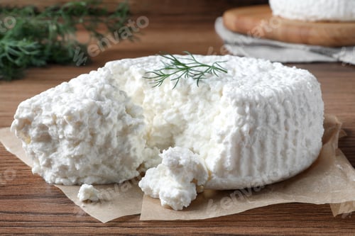 Preview: Delicious cottage cheese with dill on wooden table, closeup