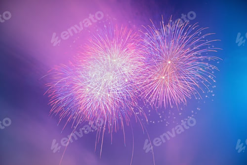 Preview: Abstract colorful beautiful fireworks salute against blue sky. Neon Holographic pattern of salute