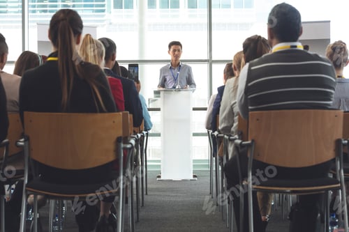 Preview: Business professionals attending seminar with businessman in office building