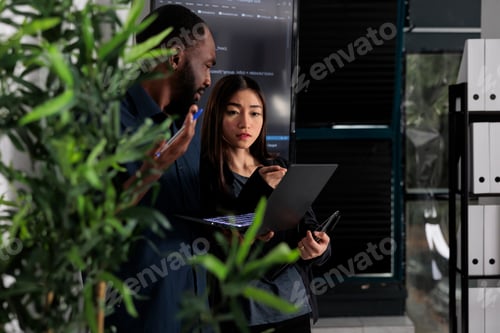 Preview: Multi ethnic team of system developers analyzing html code