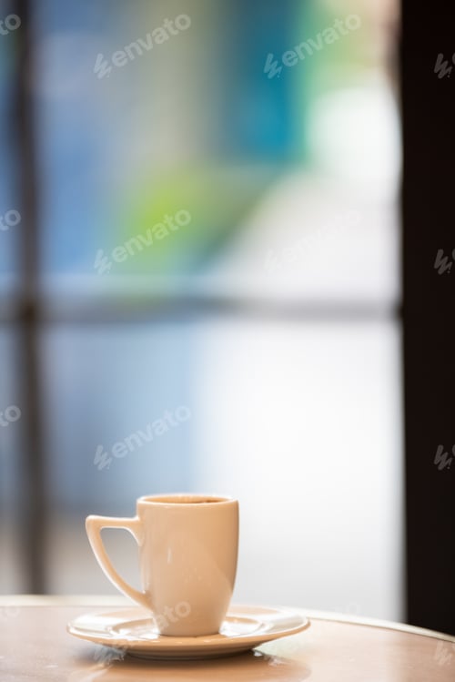 Vista previa: Cup of coffee on a round table, vertical.