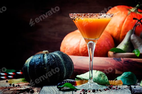 Preview: Orange halloween cocktail from pumpkin juice on a dark festive background, selective focus