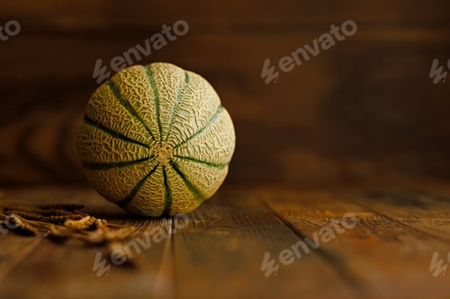 Preview: autumn still life with melon in a dark key on a wooden background