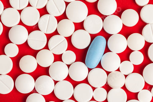 Preview: Many medicine pills close up on red background