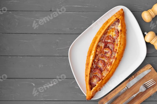 Preview: Turkish stuffed flatbread pide on gray wooden table