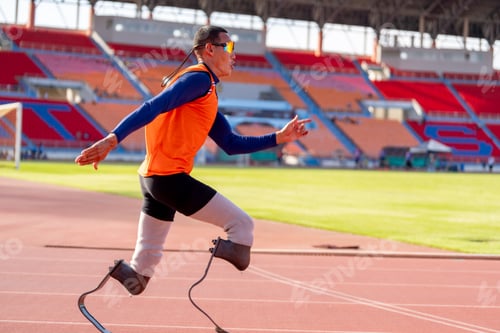 Preview: Asian para-athletes with prosthetic blades sprint on a running track at stadium.