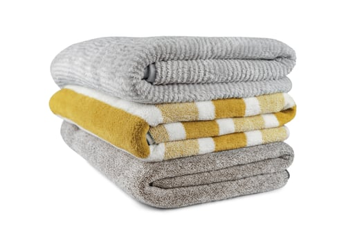 Preview: Soft Fluffy Striped Grey And Yellow Bath Towels Folded In Stack Isolated On White Background