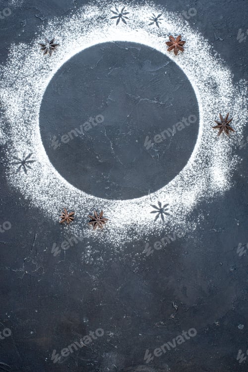Preview: top view of circular frame made of wheat flour anise stars on table