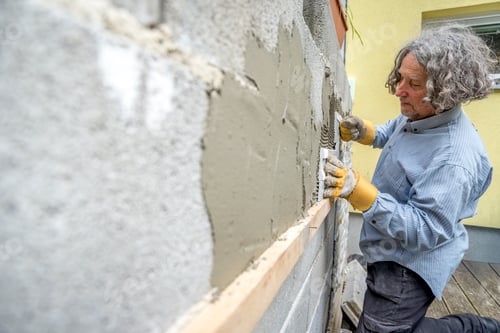 Preview: Builder applying tiles to a wall