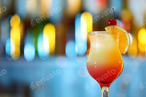 Preview: Glass of fresh alcoholic cocktail against blurred background. Space for text