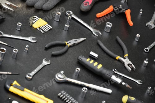 Preview: Handyman tool kit on black wooden table. Many wrenches and screwdrivers
