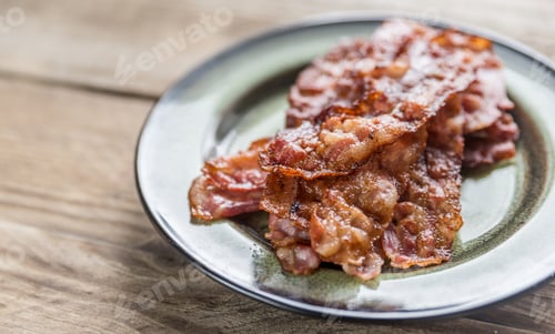 Preview: Stack of fried bacon strips on the plate