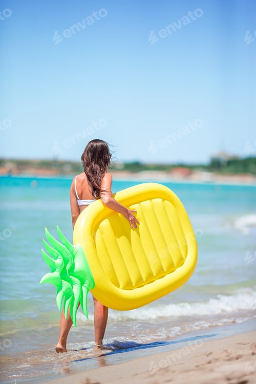 Preview: Young woman in swimsuit on the beach vacation ready to swim