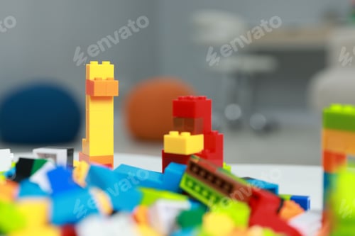 Preview: Construction toy. Figures made with building bricks and colorful blocks on table indoors, closeup