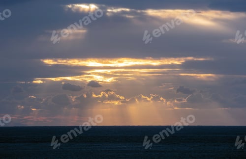 Preview: Seascape. Golden sunbeam through overcast, dark blue Aegean sea. Cyclades island destination Greece.