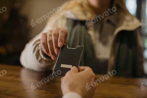 Preview: Handing hotel key card in a hotel lobby