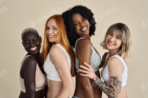 Preview: Smiling diverse young women in underwear isolated on beige background.