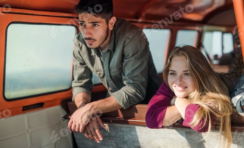 Preview: A group of young friends on a roadtrip through countryside, looking out of window.