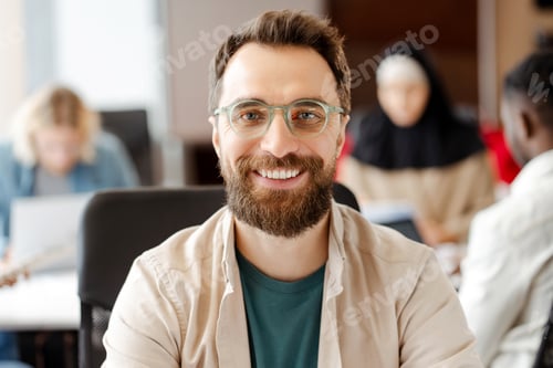Preview: Manager smiling at camera working in busy diverse office startup company meeting