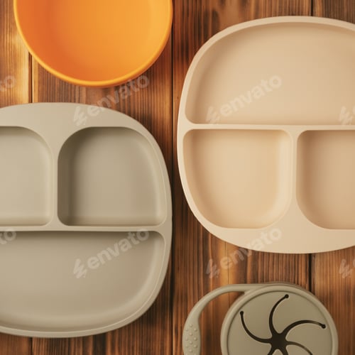 Preview: Modern colorful pastel silicone food trays, bowl and snack cup on brown wooden table. Baby tableware
