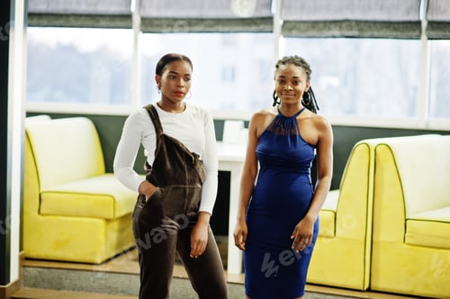 Preview: African woman in dress posing at restaurant
