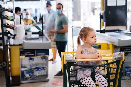 Preview: Tired kid girl in shopping cart