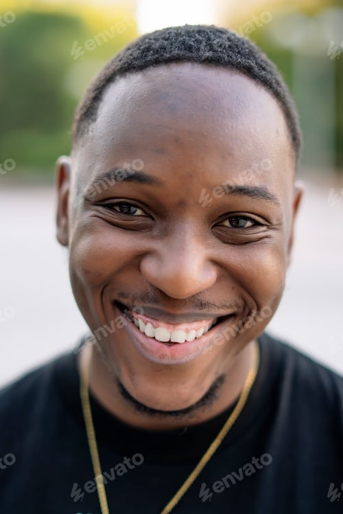 Preview: Smiling african man looking at camera