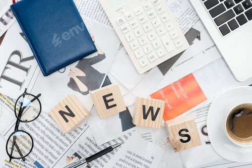 Preview: top view of wooden cubes with word news, laptop and calculator on newspapers