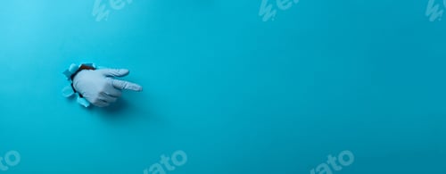 Preview: Hand in a blue medical glove is sticking out of a torn hole in a blue paper background