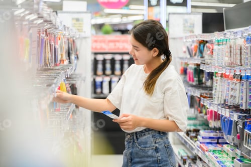Preview: young woman enjoying shopping at department store.