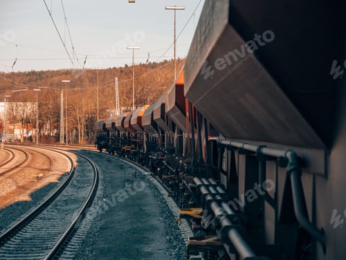 Preview: Cargo train on railways at sunset