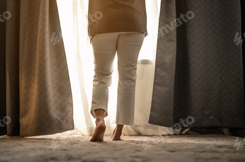 Preview: A woman waking up and open the curtains in the morning to get fresh air.