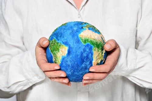 Preview: Woman holding handmade Earth model