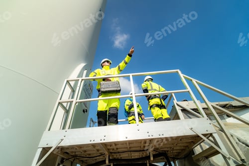 Preview: Wind turbine inspector wearing Personal protective equipment working at wind turbines farm.